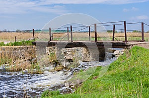 Old pedestrian bridge over small Ukrainian river Kilchen