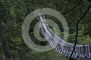 Old pedestrian suspension bridge located in rural area