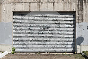 An old, peeling sheet of iron. Fence or garage door. The influence of atmospheric precipitation on the paintwork