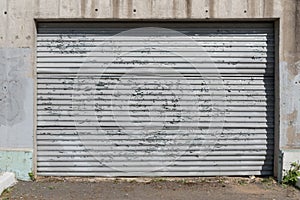 An old, peeling sheet of iron. Fence or garage door. The influence of atmospheric precipitation on the paintwork