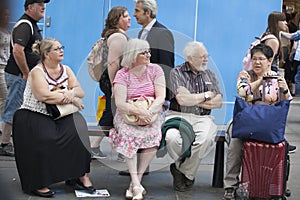 Old people in glasses sitting on bench in street. Have a little break