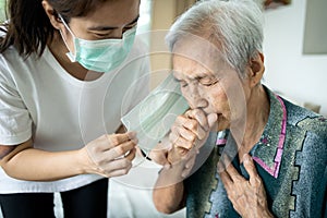 Old people have illness,fever,cough and difficulty breathing,infectious symptoms of flu,pandemic of Covid-19,asian caregiver