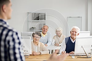 Old people listening to teacher