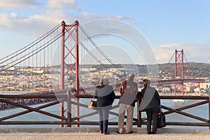 Old people looking on the 25 de Abril Bridge, Lisbon