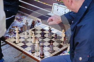 Old people play chess in the park in Lviv