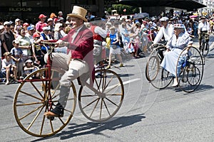 Old people riding ÃÂ©poque bicycles