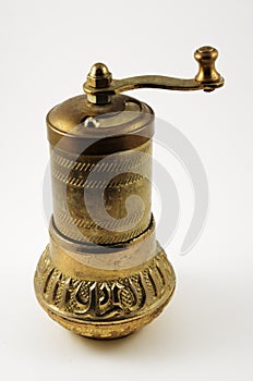 Old pepper mill on white background