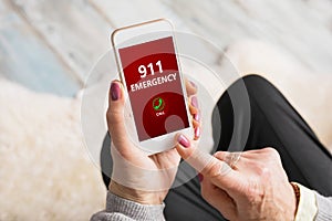 Old person dialing emergency number 911 on phone