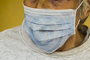 Old person is using a single use hygenic face mask photo
