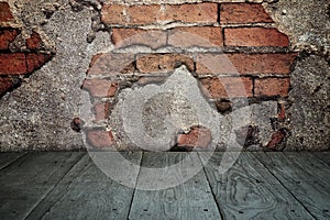 Old perspective wooden floor and cracked brick wall