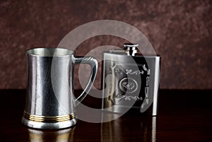Old Pewter Tankard and Steel Hip Flask on a Wooden Shelf
