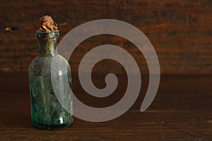 Old pharmacy bottle on antique wood background with copyspace