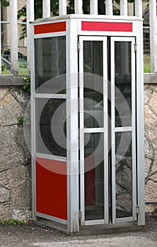 old phone booth closed on the pavement before being decommission