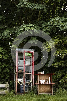 An old phone booth and some small shelfs on wadden sea island Texel in the Netherlands