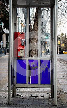 An old phonebooth that has been treated poorly photo