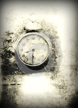 Old photo of the alarm clock - grained, scratched, overexposure