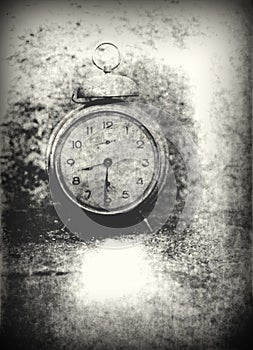 Old photo of the alarm clock - grained, scratched, overexposure