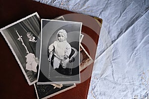 Old photo albums lie on white mint tablecloth, vintage photographs of 1960, concept of family tree, genealogy, childhood memories
