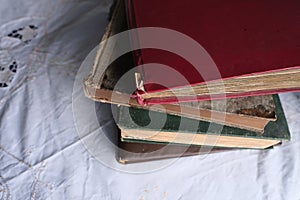 Old photo albums lie on a white mint tablecloth, vintage photographs, concept of family tree, genealogy, childhood memories,