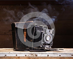 An old photo camera on a dark background photo