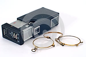 Old photo camera and pince-nez