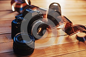 Old photo film and analog camera on table. Roll of photographic . Beautiful vintage design.