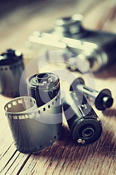 Old photo film rolls, cassette and retro camera.