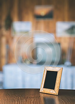 Old photo frame on the wooden table