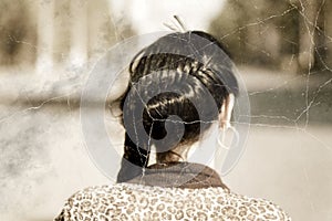 Old photo stylized headshot of a braided brunette women from back