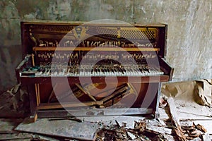 Old piano in abandoned apartment in ghost town Pripyat in Chernobyl Exclusion Zone, Ukraine