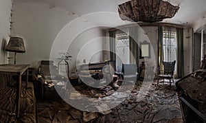 old piano in a demolished room from a house panorama