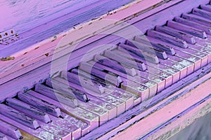 Old piano keys painted in purple