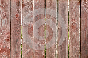 Old picket fence with faded red paint, abstract backdrop texture