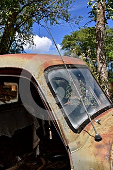 An old pickup with an antenna on front of hood