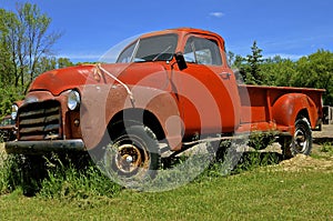 Old pickup with strapped down hood