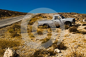 Old pickup truck on desert roadsid. Travel by car. Tourism and journey theme. Transportation, adventure concept. Summer holiday