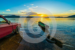 Old pickup truck parked on the waterfront with sunset at Bang phra reservoir ,sriracha chon buri,  thailand