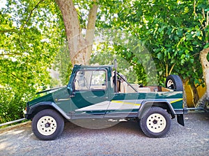 Old pickup truck on a rural road. Classic green car