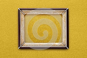 Old picture frame on a gold background