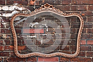 Old picture frame a a red brick wall