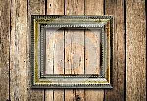 Old picture frame on vintage wood wall.