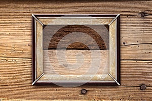 Old picture frame on a wooden background