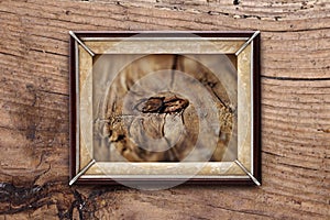 Old picture frame on a wooden background