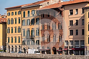 Old picturesque houses at the Arno river waterfront in Pisa