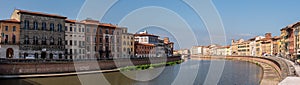 Old picturesque houses at the Arno river waterfront in Pisa