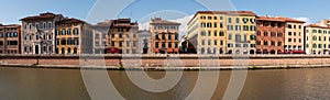 Old picturesque houses at the Arno river waterfront in Pisa