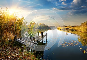 Old pier on autumn river