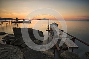 Old Pier, boat and rocks sunset