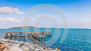 Old pier bridge in the calmness sea with blue sky