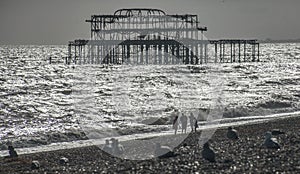 The old pier in Brighton and the beach.